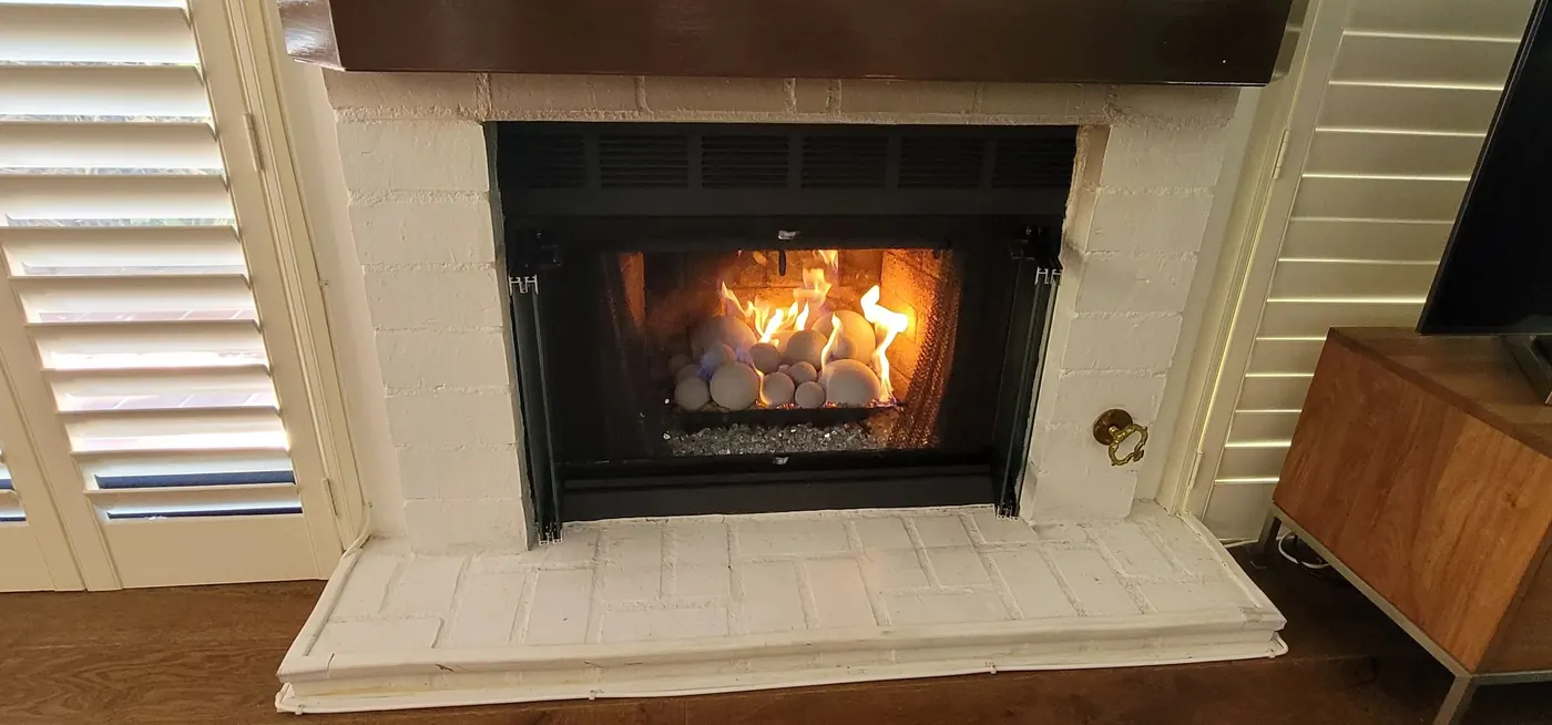 Fireballs and fire glass burning in a fireplace installed by 1st Class