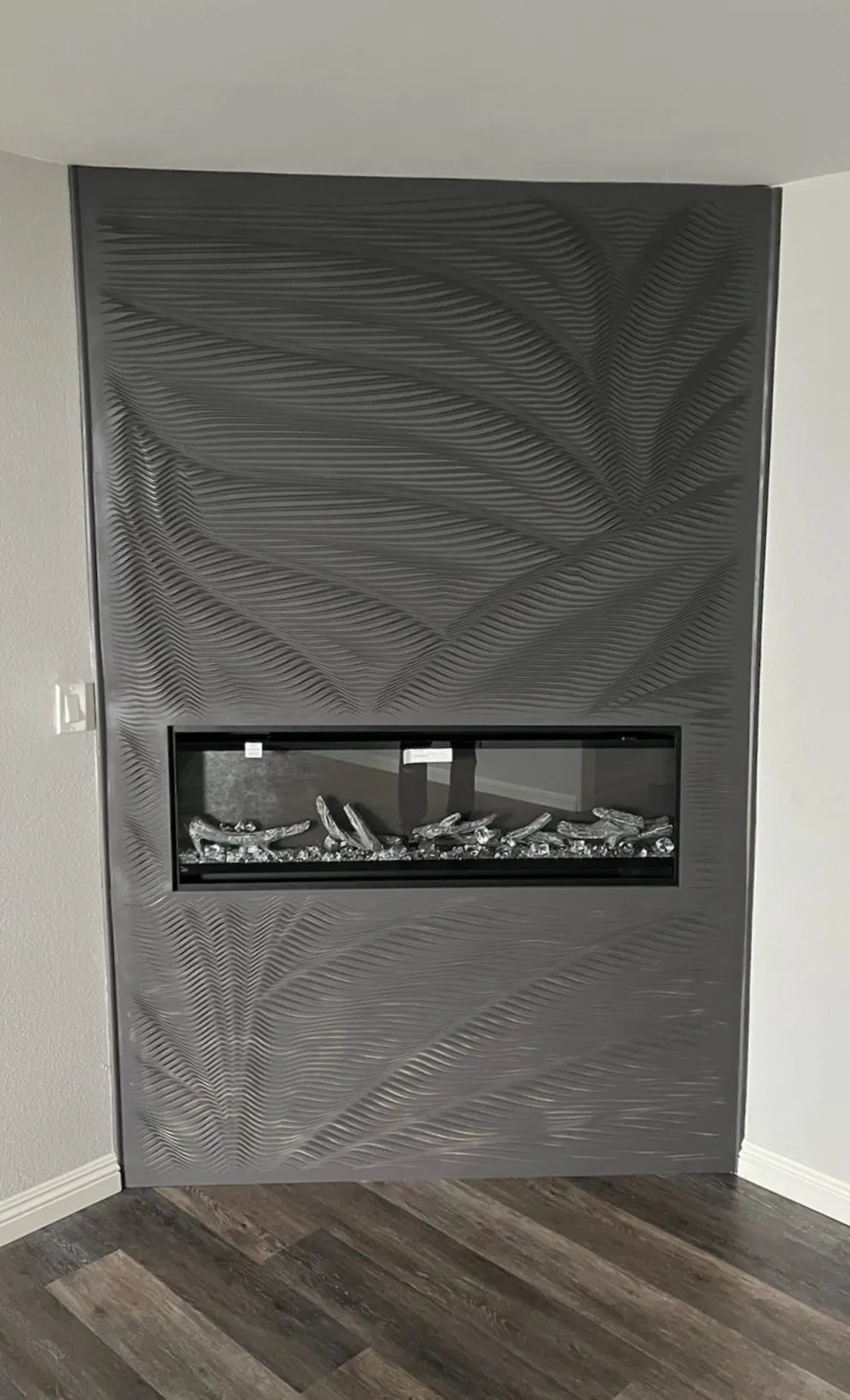 Modern fireplace with textured black facing by 1st Class